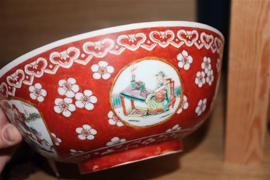 A Chinese porcelain bowl, decorated with figures in reserves on an iron red ground and two other items,